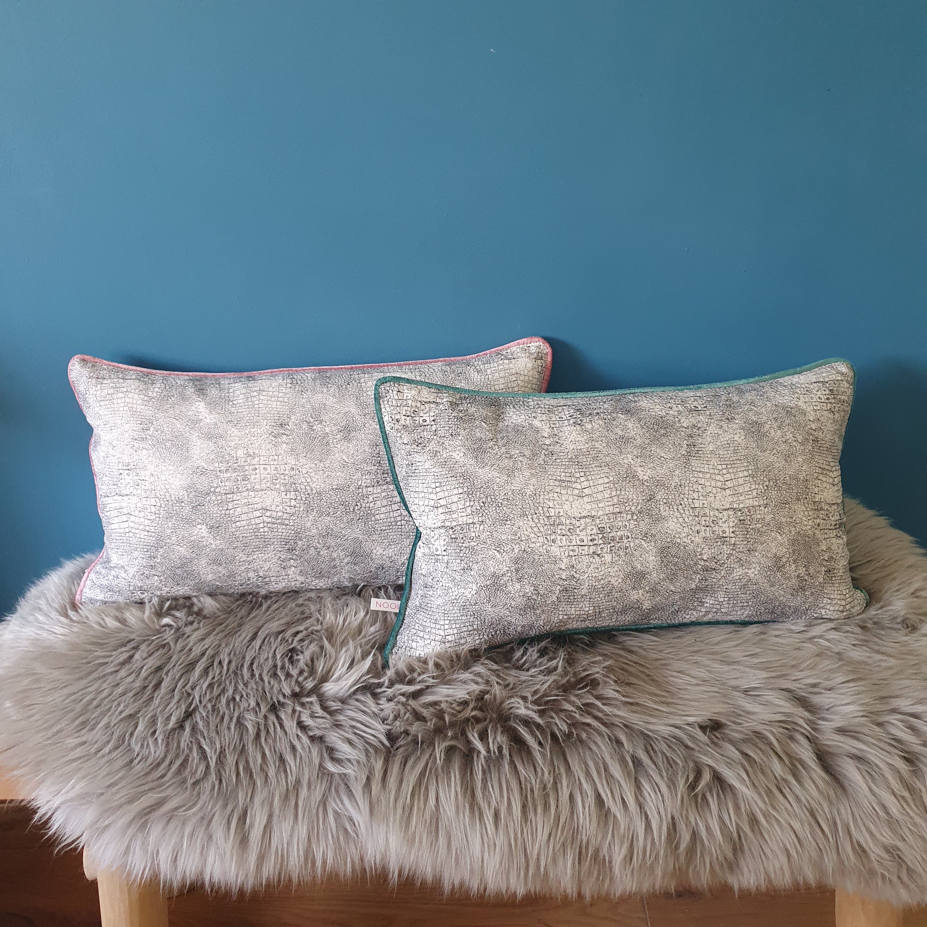 Abstract animal print velvet cushion with seafoam velvet piping