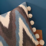 Load image into Gallery viewer, Moontide Ikat Rectangular Cushion with pom poms
