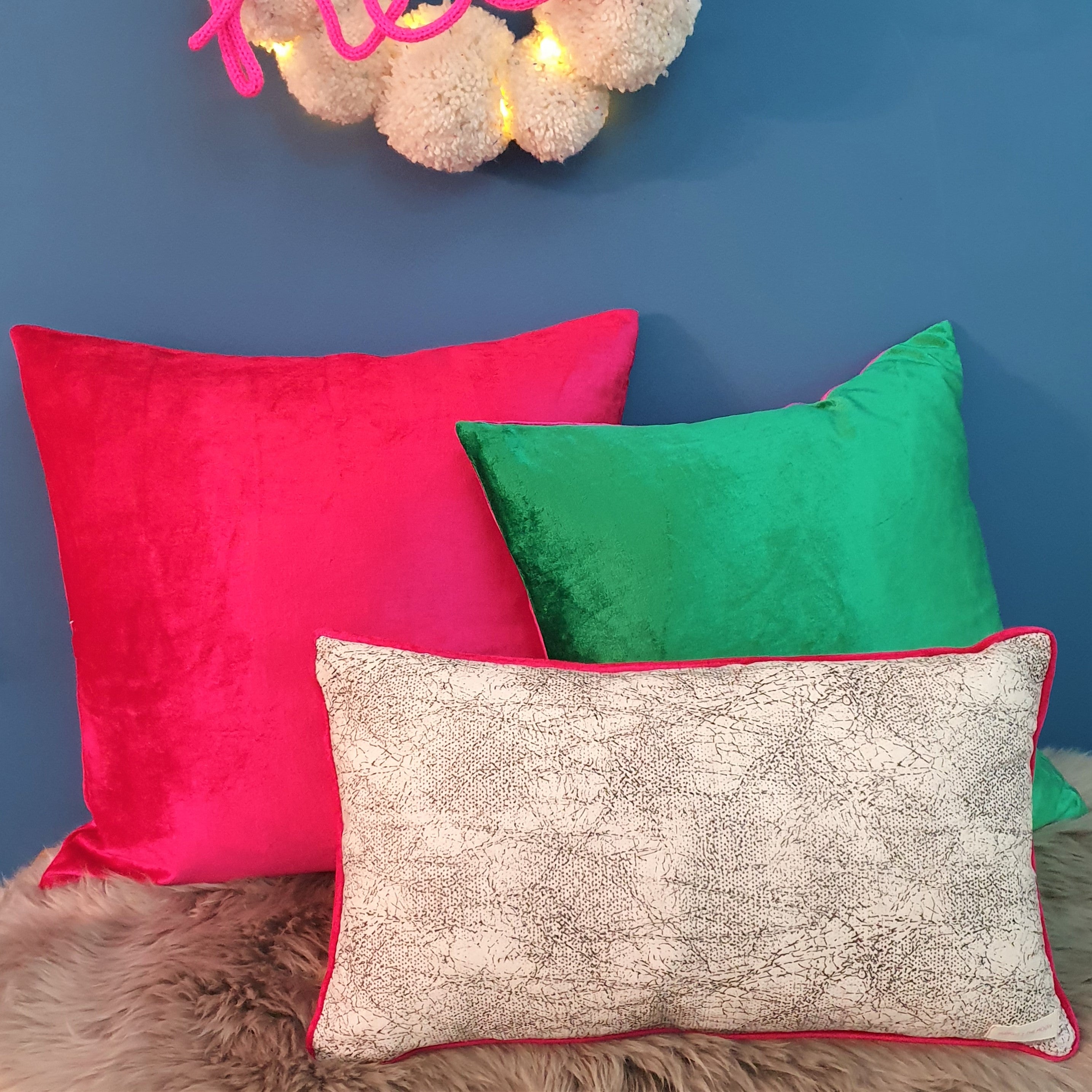 Abstract animal print velvet cushion with shocking pink velvet piping
